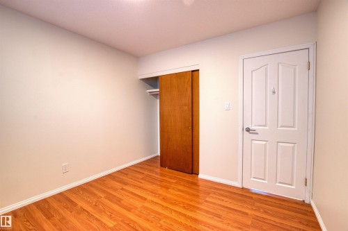 Unfurnished bedroom featuring light wood-style floors and a closet - 9907 165 Street, Edmonton, AB - Indoor Photo Showing Other Room
