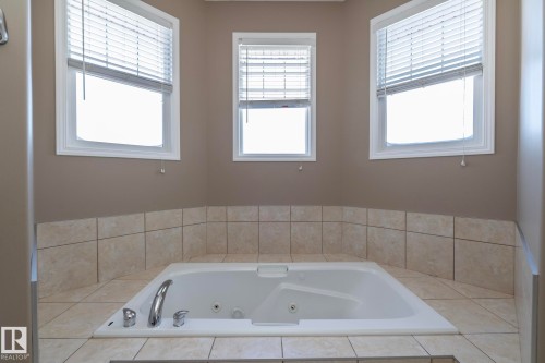 Full bath with a whirlpool tub - 16454 61A Street, Edmonton, AB - Indoor Photo Showing Bathroom