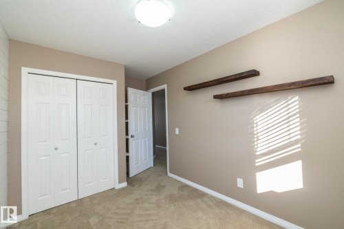 Unfurnished bedroom with light carpet and a closet - 16454 61A Street, Edmonton, AB - Indoor
