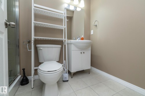 Bathroom with vanity, a shower stall, and light tile patterned floors - 16454 61A Street, Edmonton, AB - Indoor Photo Showing Bathroom