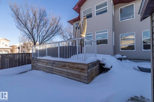 View of snowy exterior featuring a deck - 16454 61A Street, Edmonton, AB - Outdoor With Deck Patio Veranda With Exterior