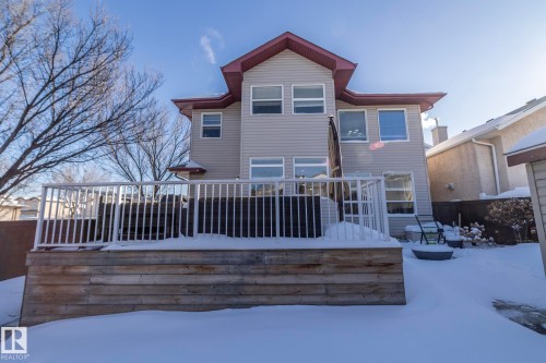 Snow covered back of property featuring a wooden deck - 16454 61A Street, Edmonton, AB - Outdoor