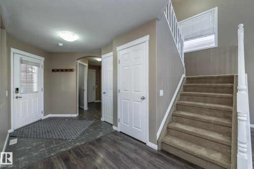 Entryway with arched walkways and dark wood finished floors - 16454 61A Street, Edmonton, AB - Indoor Photo Showing Other Room