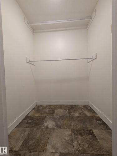 Walk in closet featuring stone finish flooring - 109 7220 144 Avenue, Edmonton, AB - Indoor With Storage