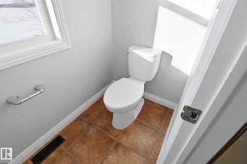 Bathroom featuring baseboards and tile patterned floors - 12634 16A Avenue, Edmonton, AB - Indoor Photo Showing Bathroom