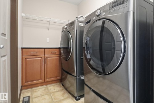 Laundry room featuring washing machine and clothes dryer and cabinet space - 12634 16A Avenue, Edmonton, AB - Indoor Photo Showing Laundry Room