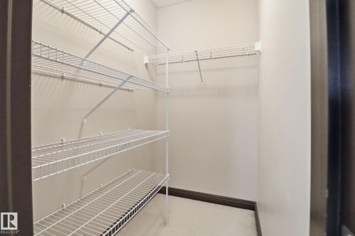 View of walk in closet - 12634 16A Avenue, Edmonton, AB - Indoor With Storage