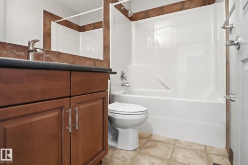 Bathroom featuring vanity and washtub / shower combination - 12634 16A Avenue, Edmonton, AB - Indoor Photo Showing Bathroom