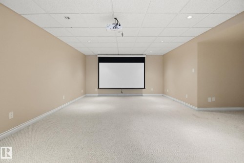 Carpeted home theater with baseboards and a drop ceiling - 12634 16A Avenue, Edmonton, AB - Indoor Photo Showing Other Room