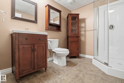 Bathroom with a paneled ceiling, a stall shower, and vanity - 12634 16A Avenue, Edmonton, AB - Indoor Photo Showing Bathroom