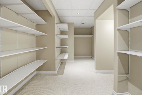 Walk in closet with a paneled ceiling and light colored carpet - 12634 16A Avenue, Edmonton, AB - Indoor Photo Showing Other Room