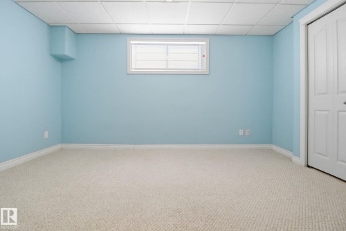 Unfurnished bedroom with a paneled ceiling, carpet floors, and a closet - 12634 16A Avenue, Edmonton, AB - Indoor Photo Showing Other Room