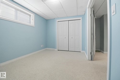Unfurnished bedroom featuring a paneled ceiling, carpet, and a closet - 12634 16A Avenue, Edmonton, AB - Indoor Photo Showing Other Room