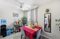 Dining space featuring wood finished floors, a textured ceiling, and ceiling fan - 