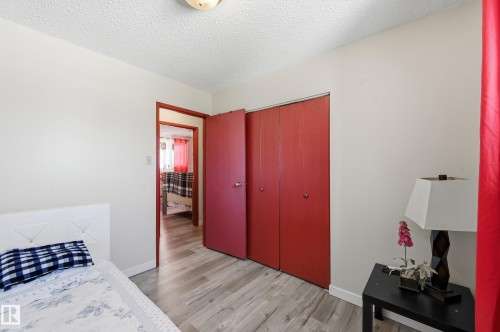 Bedroom featuring a closet, a textured ceiling, and light wood-style flooring - 1482 Lakewood Road W, Edmonton, AB - Indoor Photo Showing Bedroom