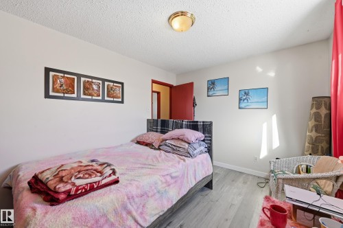 Bedroom with wood finished floors and a textured ceiling - 1482 Lakewood Road W, Edmonton, AB - Indoor Photo Showing Bedroom