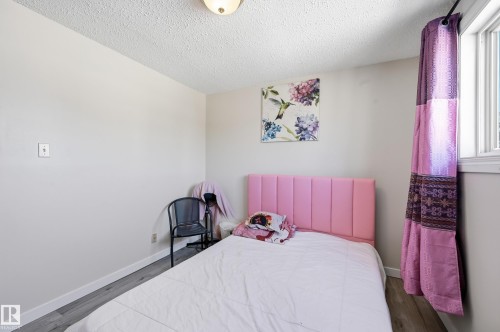 Bedroom with wood finished floors and a textured ceiling - 1482 Lakewood Road W, Edmonton, AB - Indoor Photo Showing Bedroom