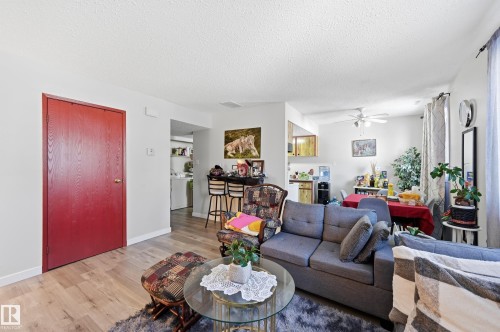 Living room featuring wood finished floors, a ceiling fan, and a textured ceiling - 1482 Lakewood Road W, Edmonton, AB - Indoor Photo Showing Living Room