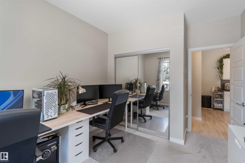 Home office featuring light carpet and a textured ceiling - 103 320 Ambleside Link Link Sw, Edmonton, AB - Indoor Photo Showing Office