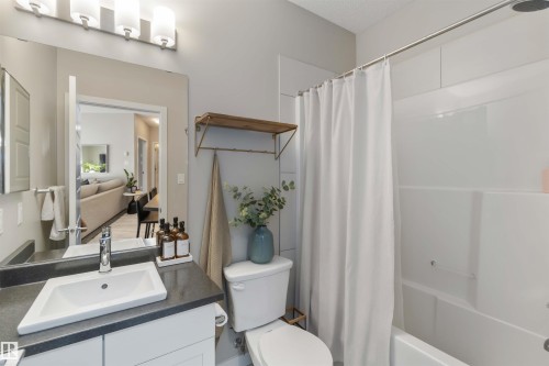 Full bathroom featuring vanity and shower / tub combo - 103 320 Ambleside Link Link Sw, Edmonton, AB - Indoor Photo Showing Bathroom