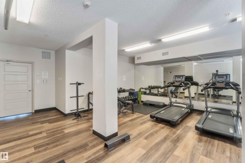 Exercise room featuring a textured ceiling - 103 320 Ambleside Link Link Sw, Edmonton, AB - Indoor Photo Showing Gym Room