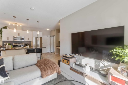 Living room featuring light wood-type flooring - 103 320 Ambleside Link Link Sw, Edmonton, AB - Indoor