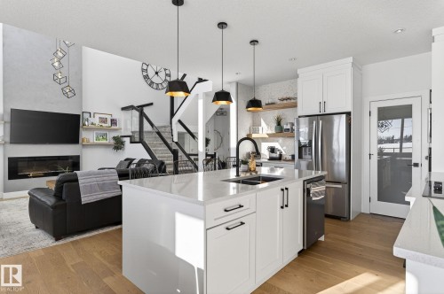 153 Henderson Link, Spruce Grove, AB - Indoor Photo Showing Kitchen With Fireplace With Double Sink With Upgraded Kitchen