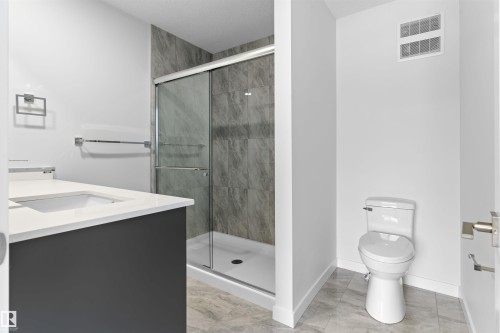 Full bath with vanity, a shower stall, and light marble finish floors - 320 Munn Way, Leduc, AB - Indoor Photo Showing Bathroom