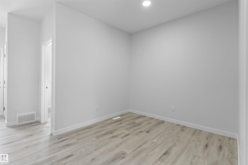 Unfurnished room featuring light wood-type flooring and recessed lighting - 320 Munn Way, Leduc, AB - Indoor Photo Showing Other Room