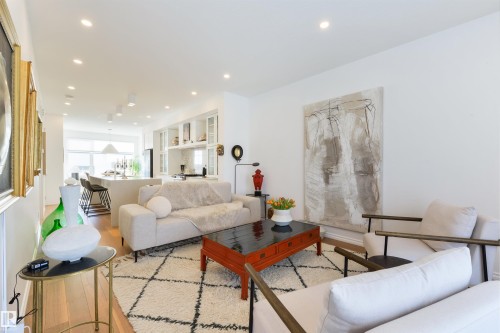 Gleamming hardwood floors, 9 ft ceiling, large windows - 7707 79 Avenue, Edmonton, AB - Indoor Photo Showing Living Room
