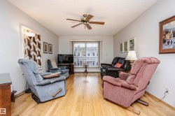 Living area featuring ceiling fan and light wood-type flooring - 