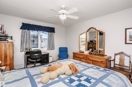 Bedroom featuring ceiling fan and a textured ceiling - 408 10935 21 Avenue, Edmonton, AB - Indoor Photo Showing Bedroom