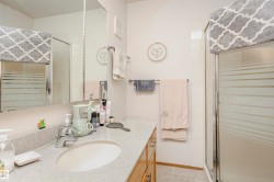 Bathroom featuring a stall shower and vanity - 