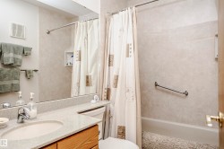 Bathroom featuring vanity and shower / bath combination with curtain - 