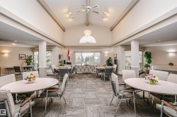 Dining space featuring a ceiling fan and a chandelier - 
