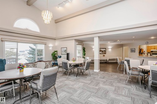 Dining space with lofted ceiling, healthy amount of natural light, and hanging lights - 408 10935 21 Avenue, Edmonton, AB - Indoor Photo Showing Dining Room