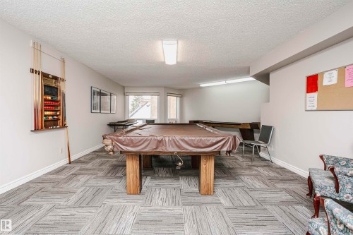Recreation room featuring billiards and a textured ceiling - 408 10935 21 Avenue, Edmonton, AB - Indoor