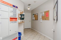 Hallway featuring baseboards and light tile patterned floors - 