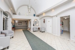 Community lobby with recessed lighting and a barrel ceiling - 