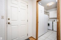 Laundry room with a textured ceiling, washing machine and clothes dryer, and cabinet space - 