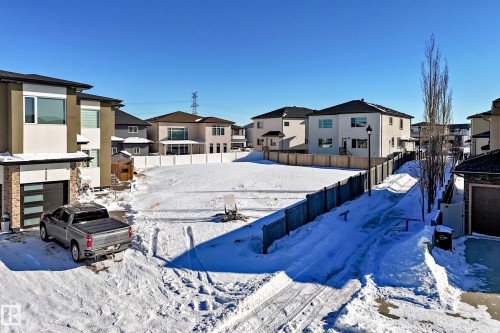 Yard layered in snow with a residential view - 1004 148 Avenue, Edmonton, AB 
