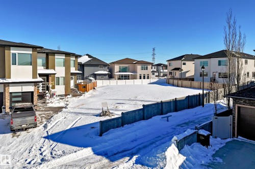 Snowy yard featuring a residential view - 1004 148 Avenue, Edmonton, AB 