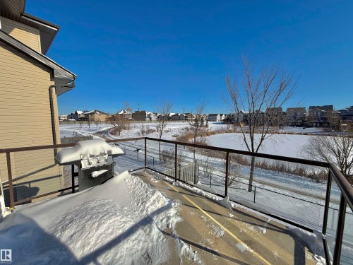 Yard covered in snow with a residential view and a balcony - 1019 174 Street, Edmonton, AB - Outdoor With View