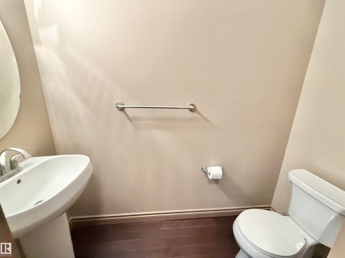 Bathroom featuring toilet and wood finished floors - 1019 174 Street, Edmonton, AB - Indoor Photo Showing Bathroom