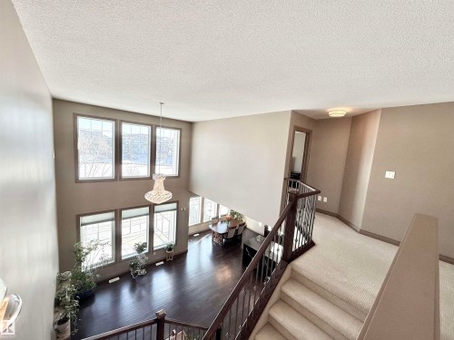 Stairway with a high textured ceiling and baseboards - 1019 174 Street, Edmonton, AB - Indoor