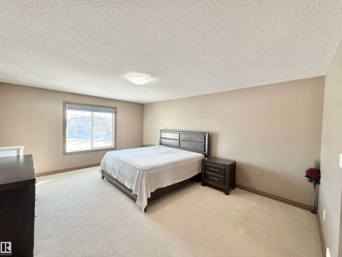 Bedroom featuring carpet flooring and a textured ceiling - 1019 174 Street, Edmonton, AB - Indoor Photo Showing Bedroom