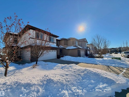 View of front of property featuring an attached garage and a residential view - 1019 174 Street, Edmonton, AB - Outdoor