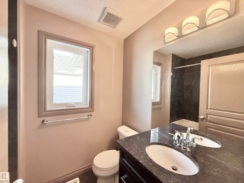 Bathroom with vanity and a textured ceiling - 1019 174 Street, Edmonton, AB - Indoor Photo Showing Bathroom