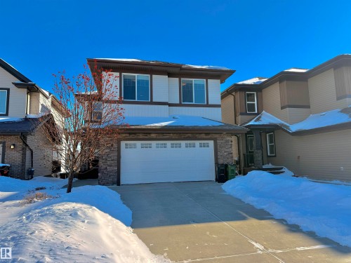 View of front of house with stone siding, a garage, and concrete driveway - 1019 174 Street, Edmonton, AB - Outdoor