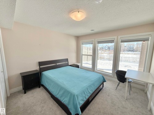 Bedroom featuring a textured ceiling and light colored carpet - 1019 174 Street, Edmonton, AB - Indoor Photo Showing Bedroom